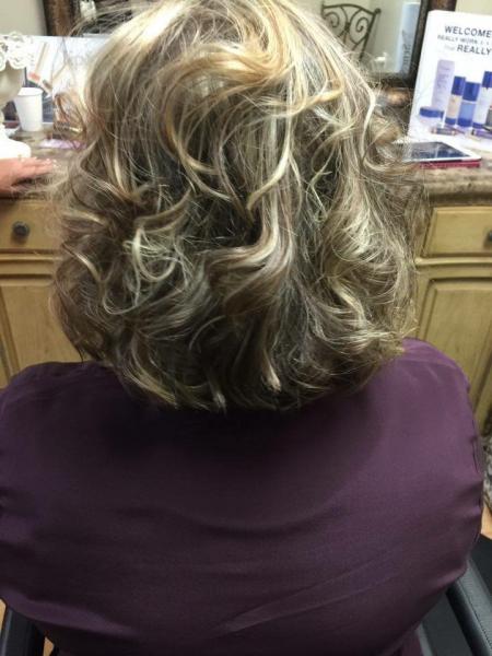 Our professional stylists will make you feel beautiful with our shampoo and style package! This woman is showing off a short hair style for women which has soft curls.