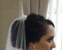 Reflections Hair Salon specializes in making brides look glamorous on their special day. This updo is styled around the bride's long veil for her special day!